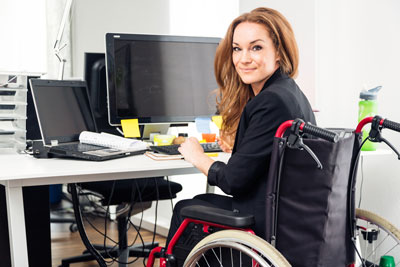 woman in wheelchair working at computer