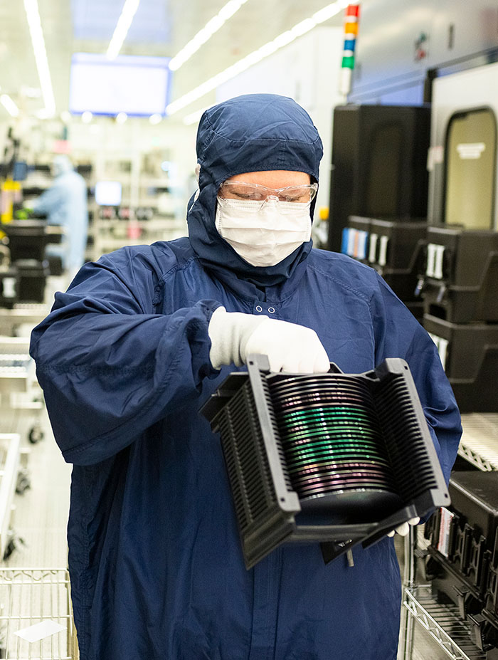 Worker handling a semiconductor in a lab