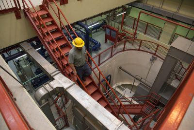 Man walking downstairs in an electrical area.