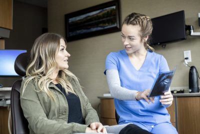 Nurse showing a patient an x-ray.