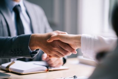 People shaking hands in an interview.