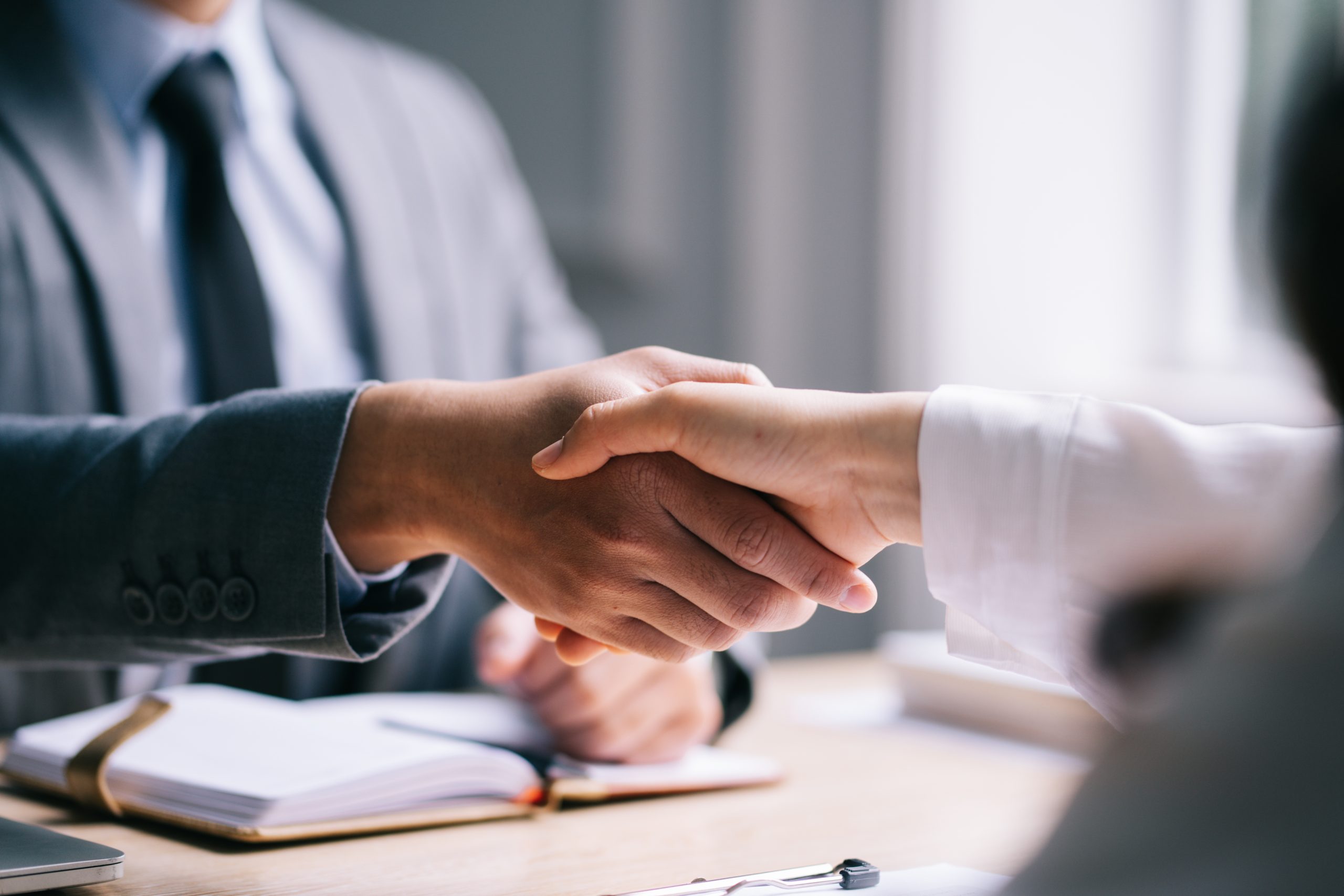People shaking hands in an interview