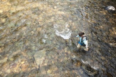 A woman working in a river.